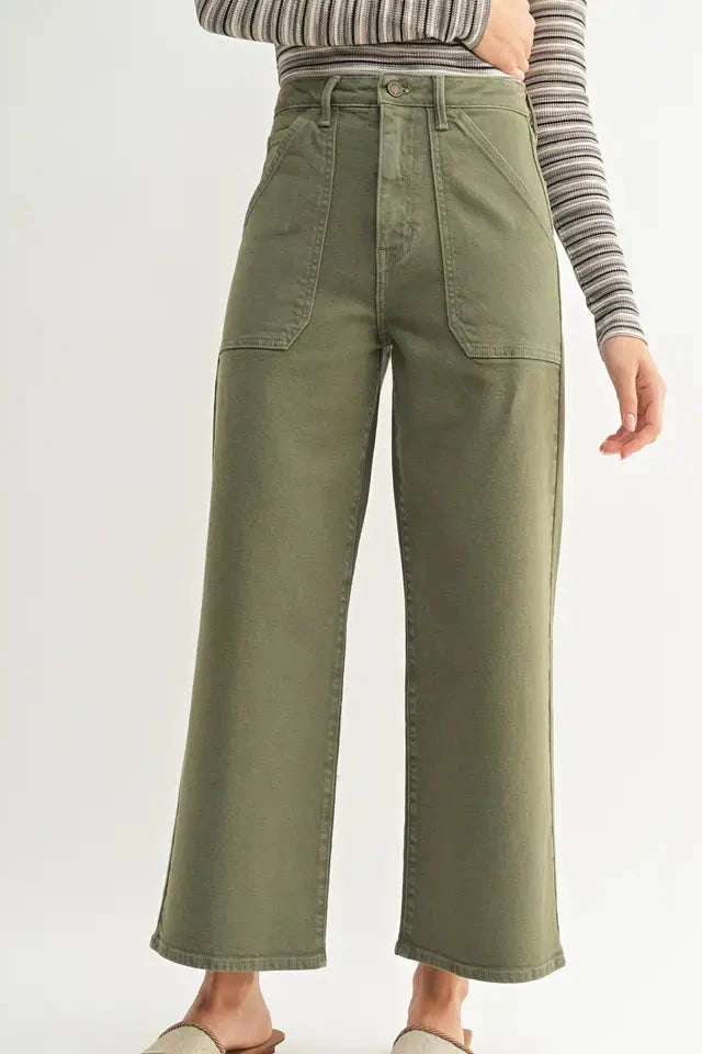 Person wearing olive green wide-leg pants on a white background