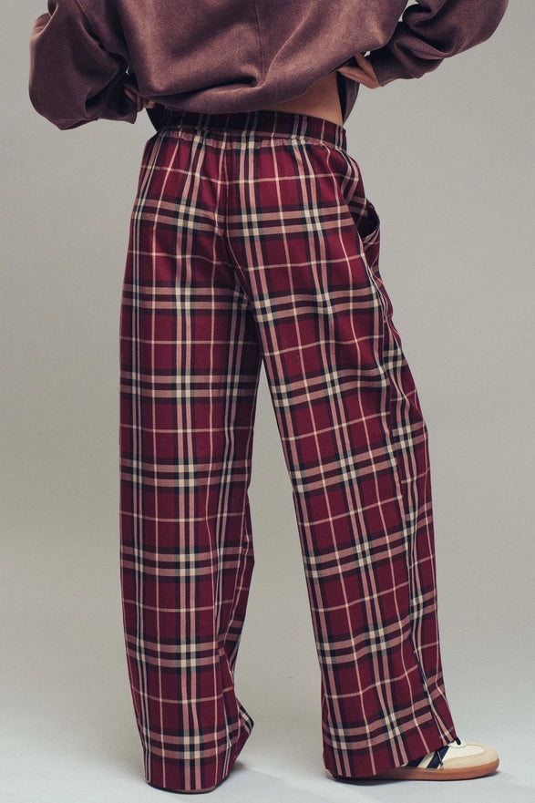 Plaid pants worn by a person on a plain background