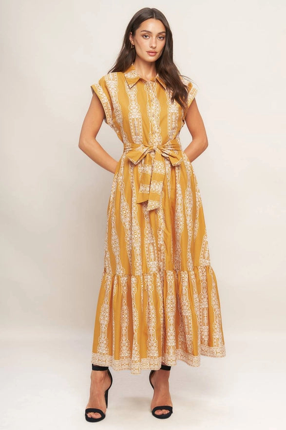 Woman wearing a yellow patterned dress on a white background