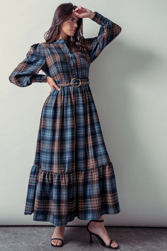 Woman wearing a blue plaid maxi dress against a plain background.