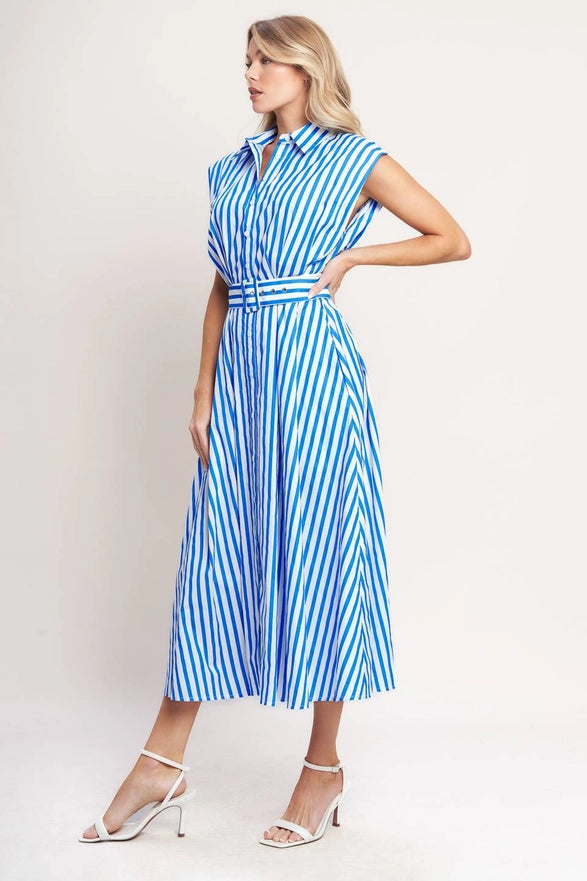 Woman wearing a blue and white striped dress on a plain background
