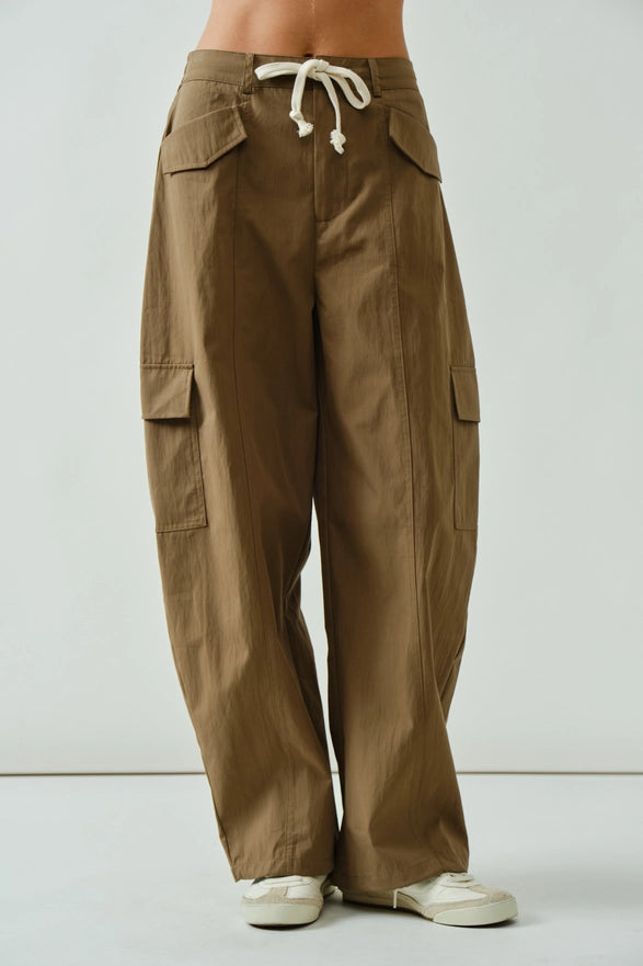 Brown cargo pants with a white background