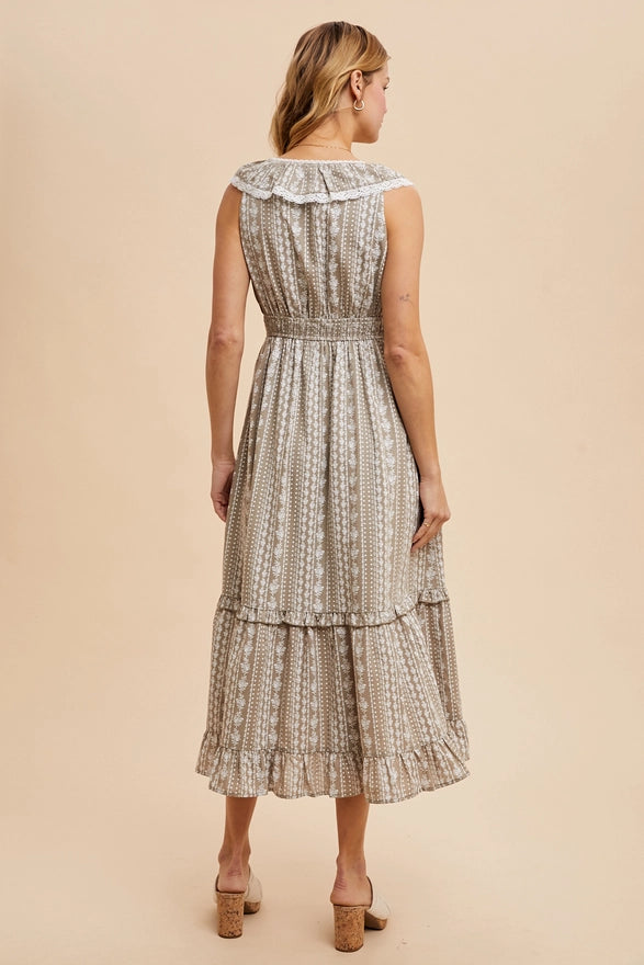 Woman wearing a patterned dress on a beige background