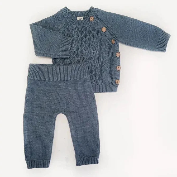 Blue knitted sweater and pants set on a white background