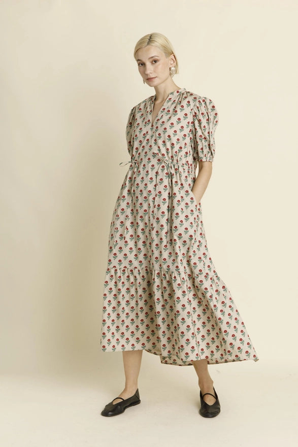 Woman wearing a floral dress on a plain background