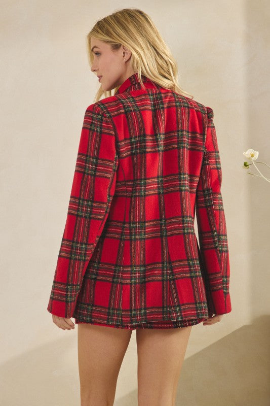 Red plaid blazer worn by a person on a plain background