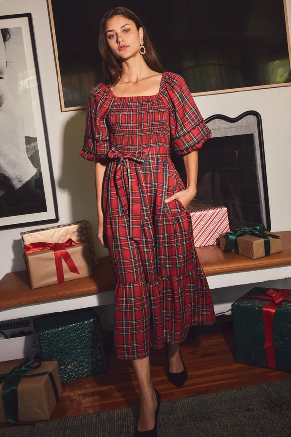 Woman wearing a red plaid midi dress with puff sleeves