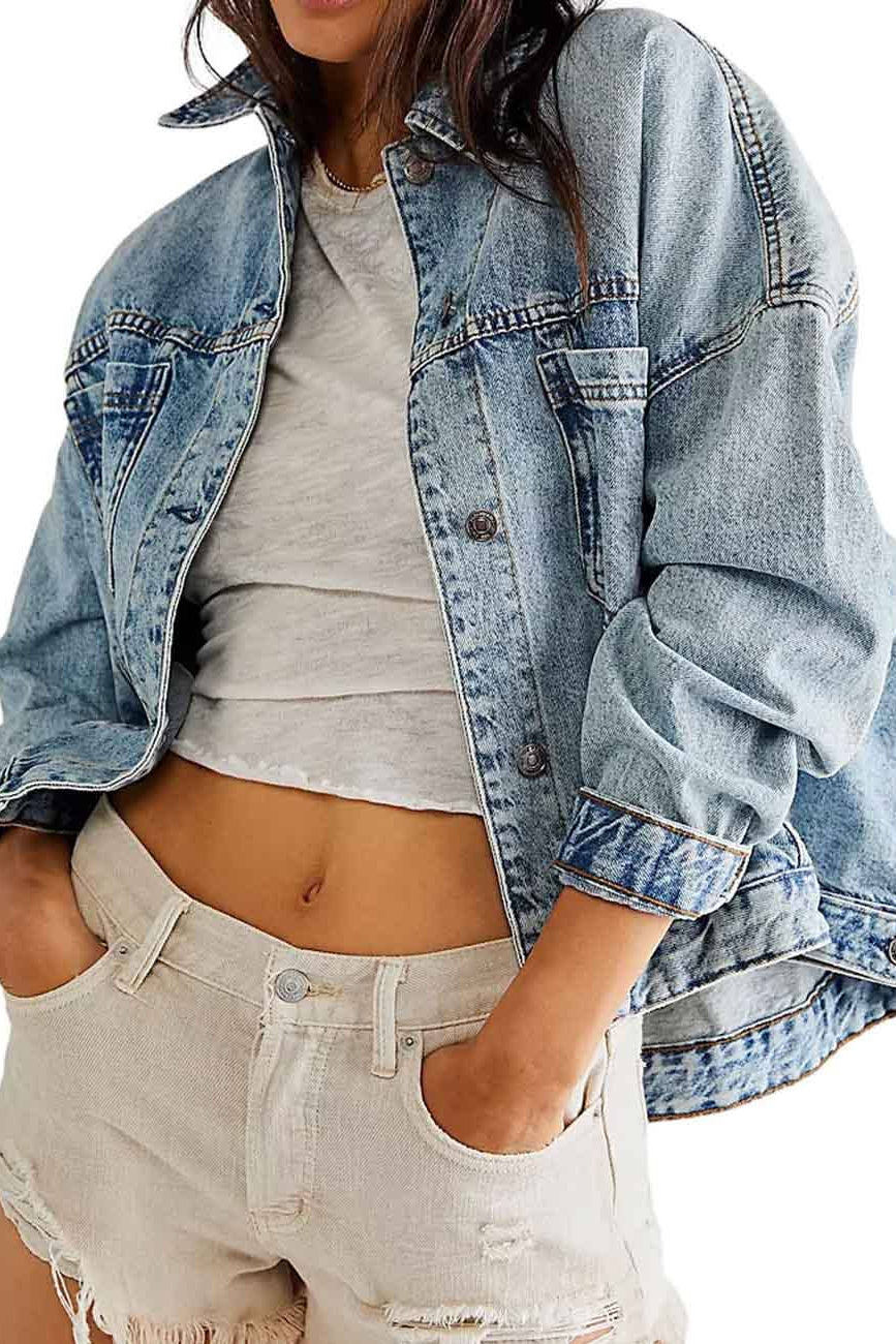 Person wearing a denim jacket, gray top, and beige shorts on a white background