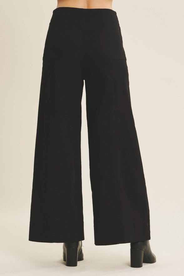 Black wide-leg pants on a neutral background