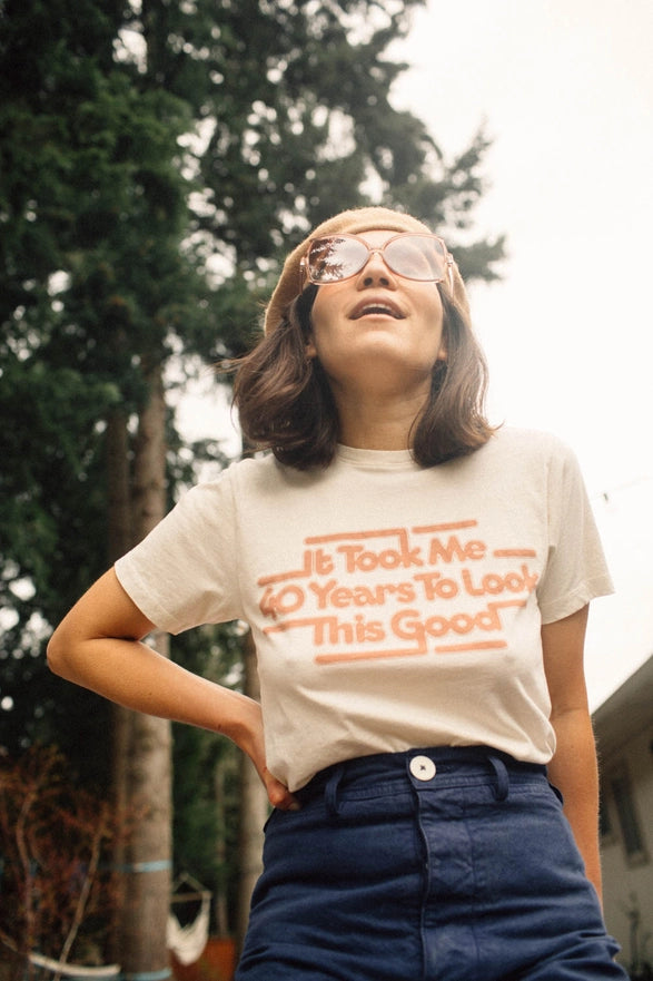 Person wearing a t-shirt with text outdoors