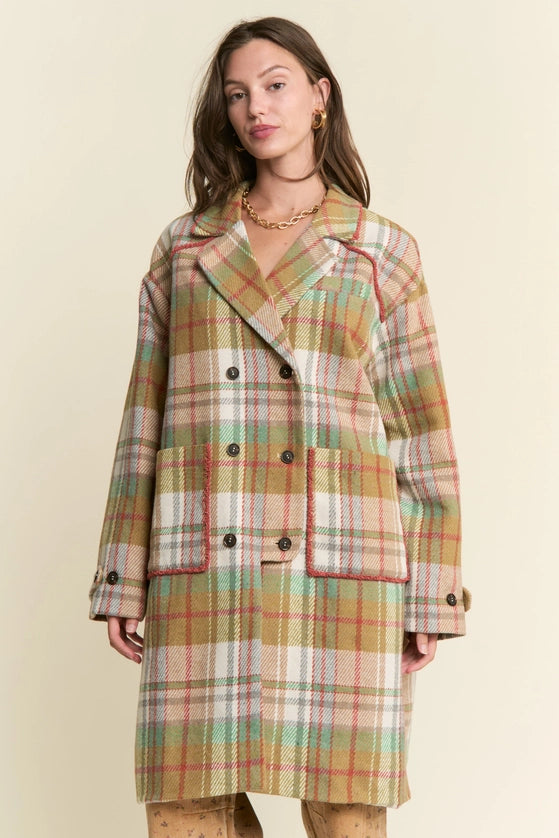 Woman wearing a plaid coat on a beige background