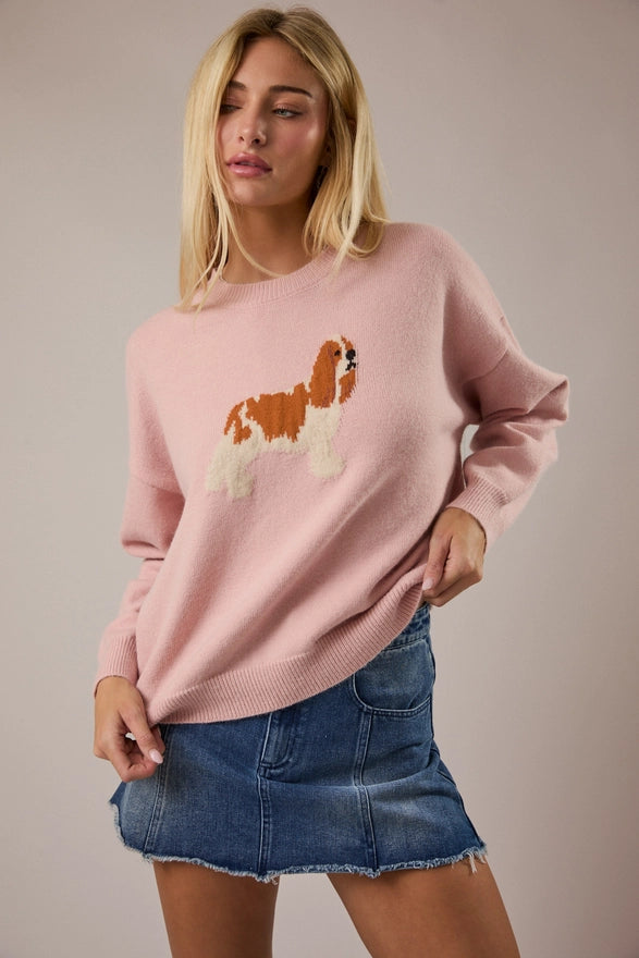 Woman wearing a pink sweater with a dog design on a beige background