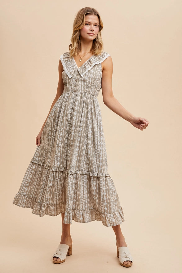 Woman wearing a patterned dress on a beige background