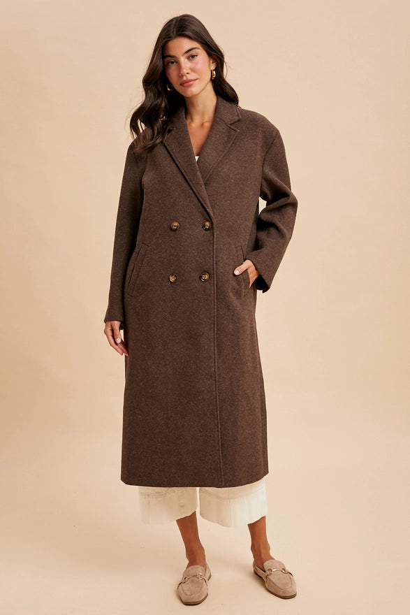 Woman wearing a brown coat on a beige background