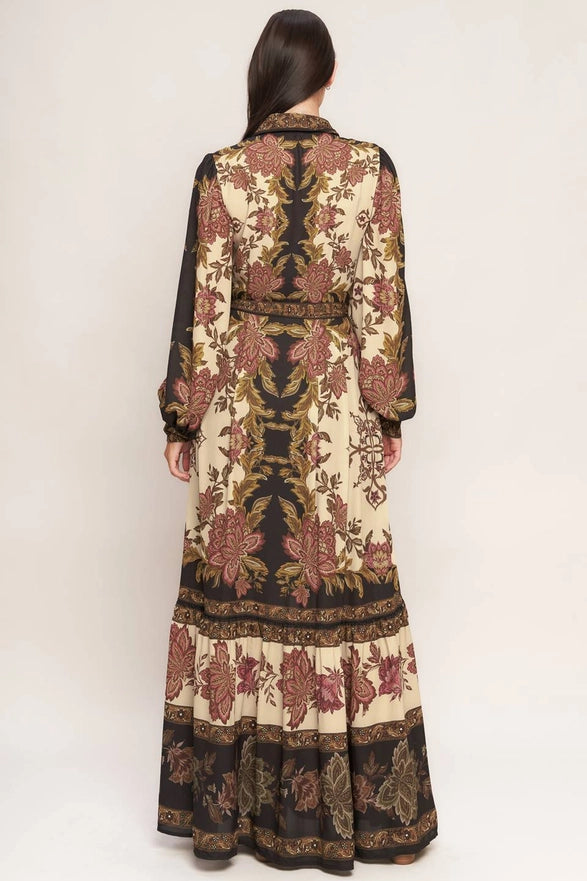 Long, patterned dress worn by a model on a white background