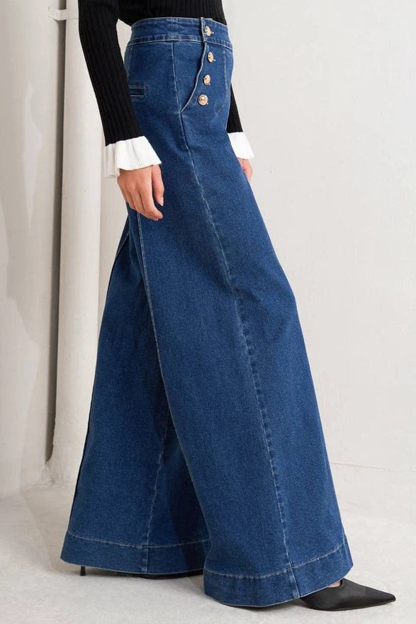 Wide-leg jeans worn by a person on a plain background