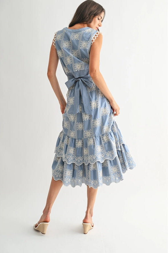 Woman wearing a blue floral dress on a white background