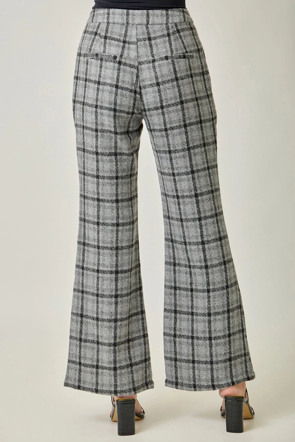 Plaid pants worn by a person on a white background