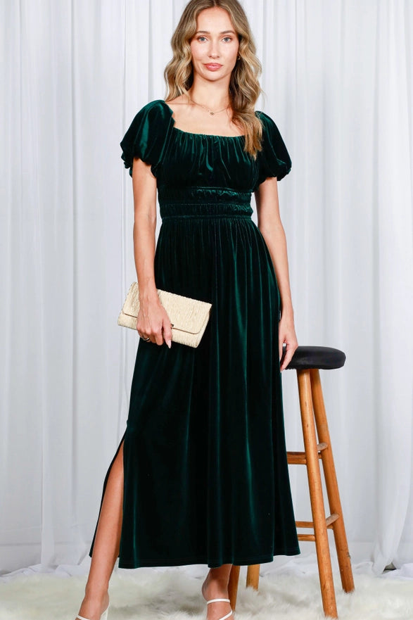 Woman wearing a green velvet dress with a white background