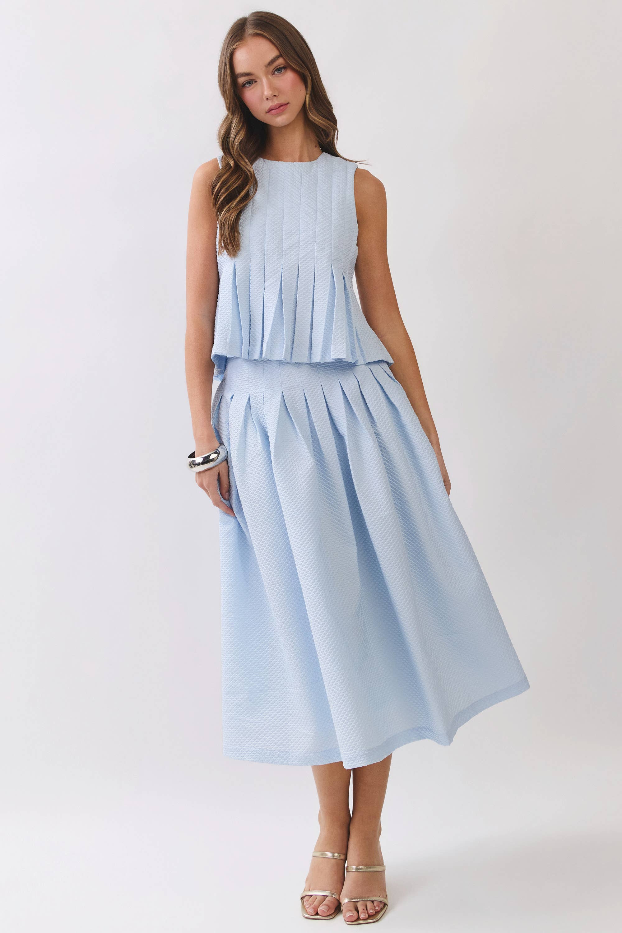 Woman wearing a light blue dress on a white background