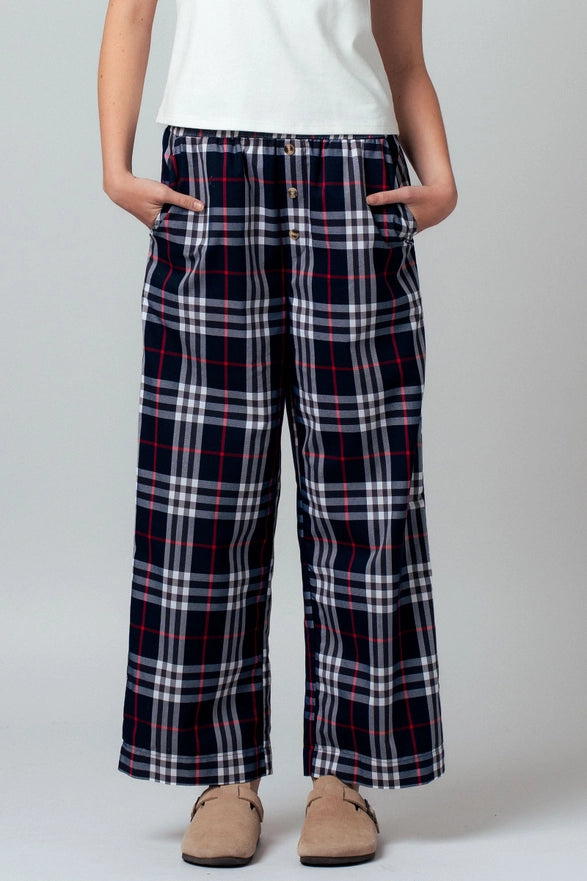 Person wearing plaid pants with a white background