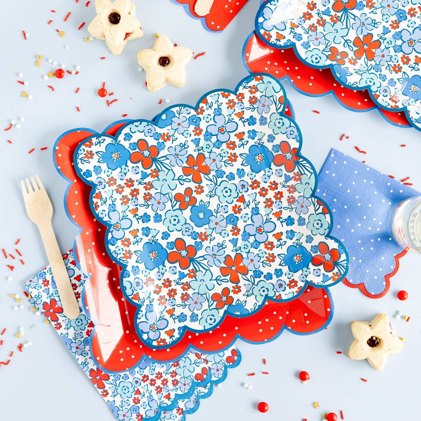 Floral-patterned plates with red borders on a light gray background