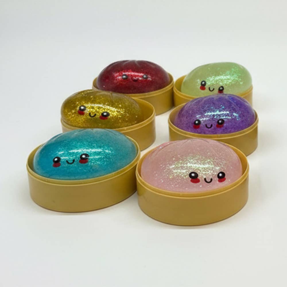 Colorful glittery balls with smiling faces in gold, red, green, purple, blue, and pink containers on a white background. squishy glitter dumpling