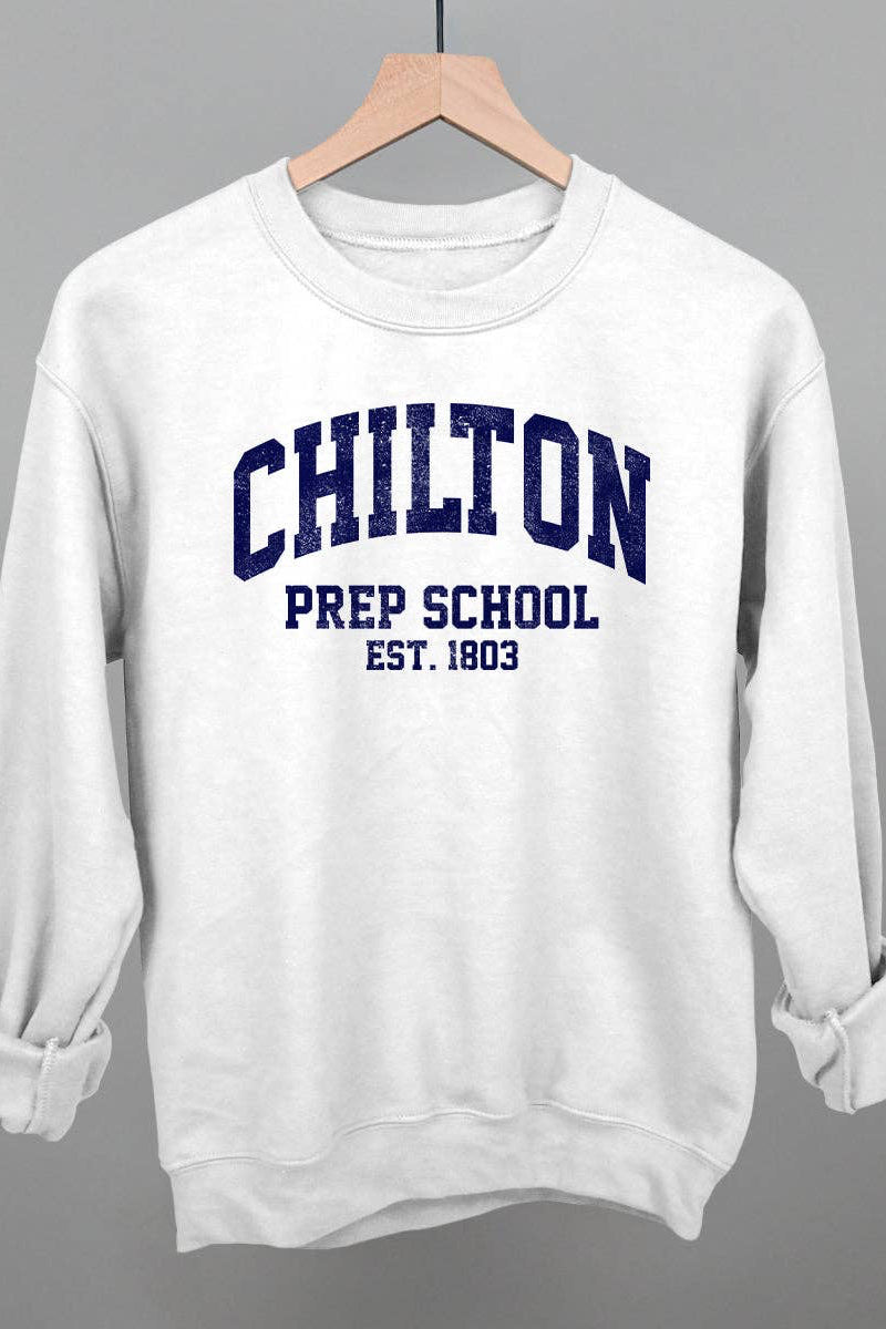 A white crewneck sweatshirt hanging on a wooden hanger against a solid gray background. The sweatshirt features navy blue collegiate-style text reading 'CHILTON PREP SCHOOL EST.