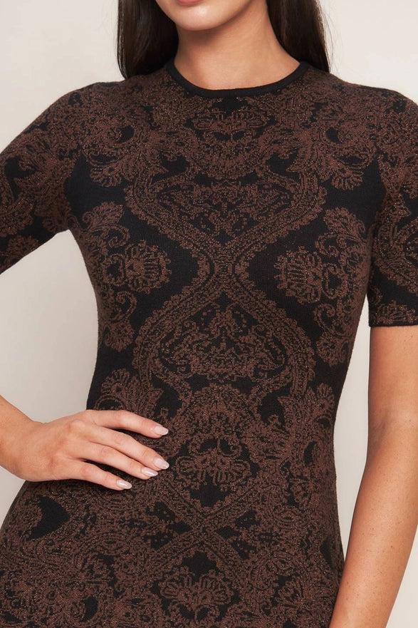 Black lace dress worn by a model against a white background