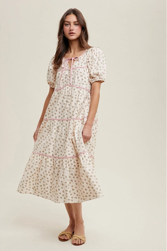 Woman wearing a floral dress on a plain background