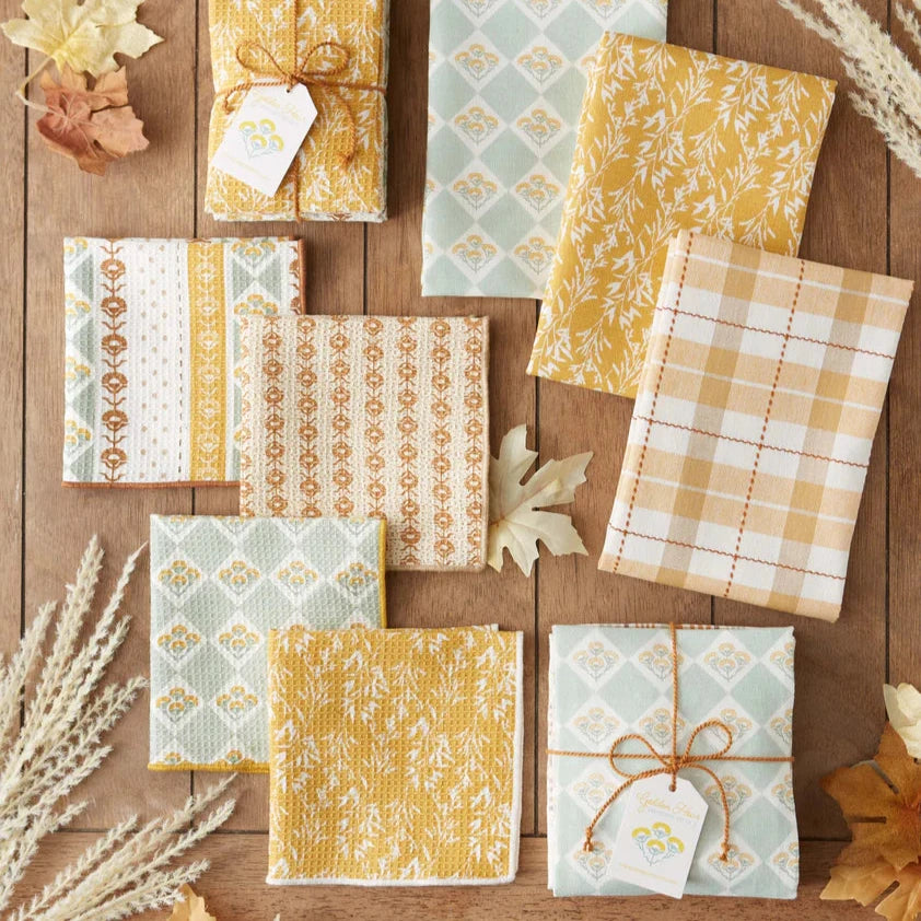 Collection of patterned paper sheets on a wooden surface with decorative elements.