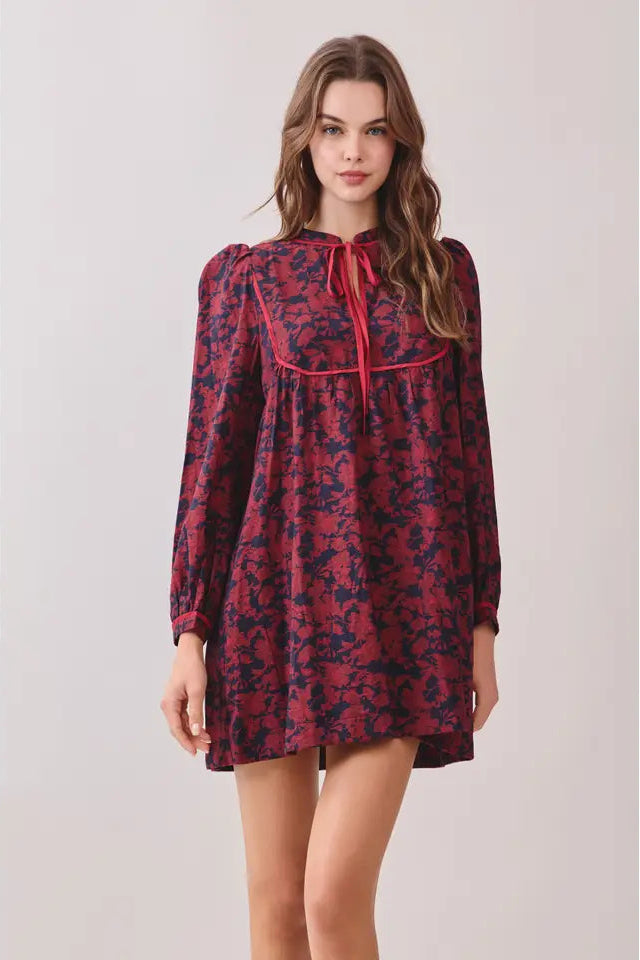 Woman wearing a red and blue patterned dress on a white background