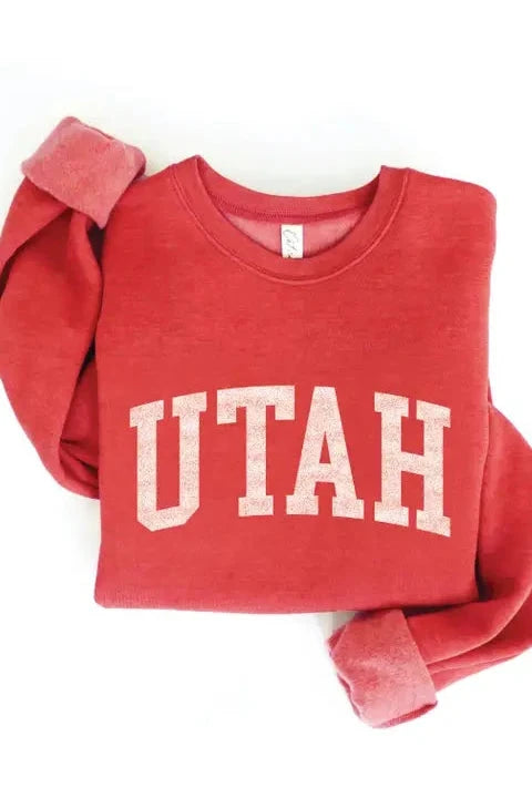 Red sweatshirt with 'UTAH' printed on it against a white background