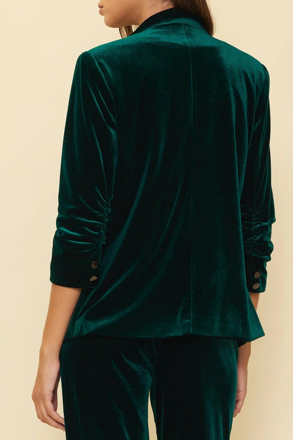 Green velvet suit on a beige background