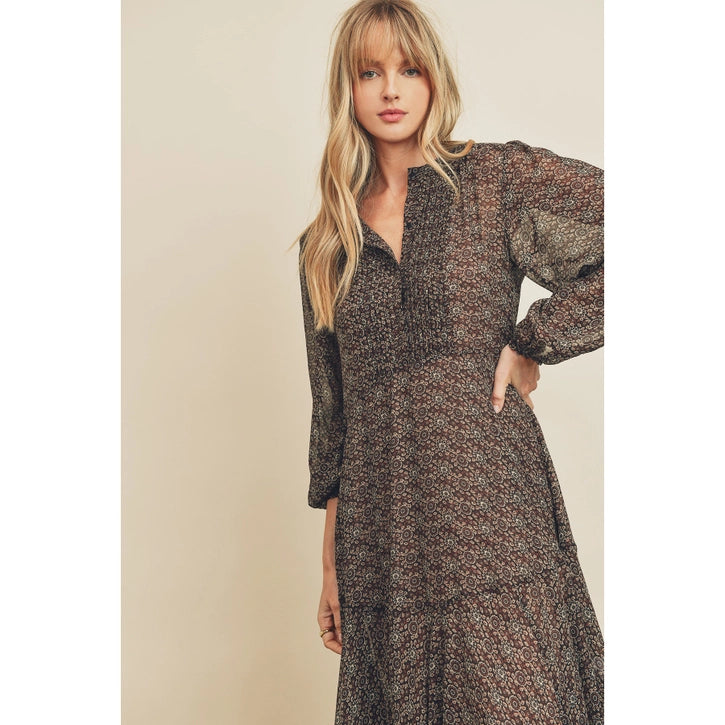 Woman wearing a patterned dress against a beige background