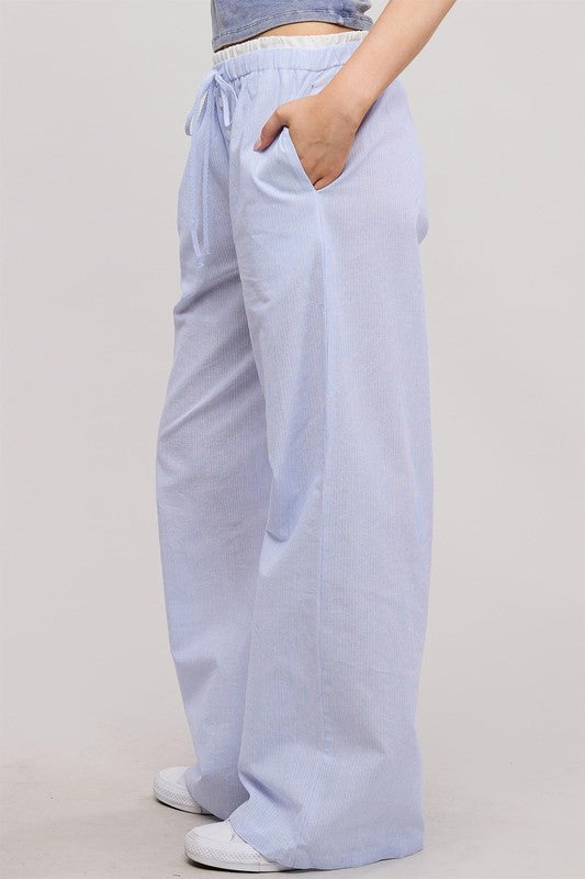 Light blue pants worn by a person on a plain background