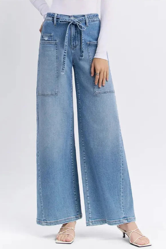 Light blue wide-leg jeans worn by a person on a white background