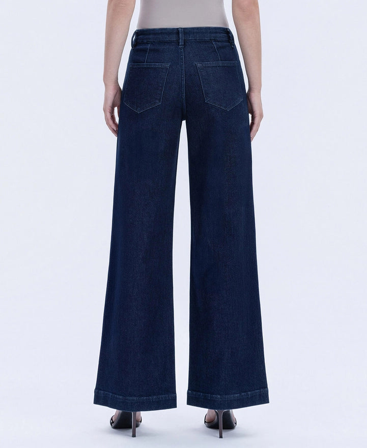 Dark blue wide-leg jeans worn by a person on a white background