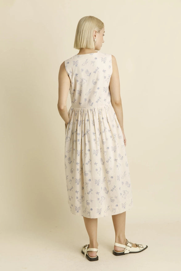 Woman wearing a floral dress on a beige background