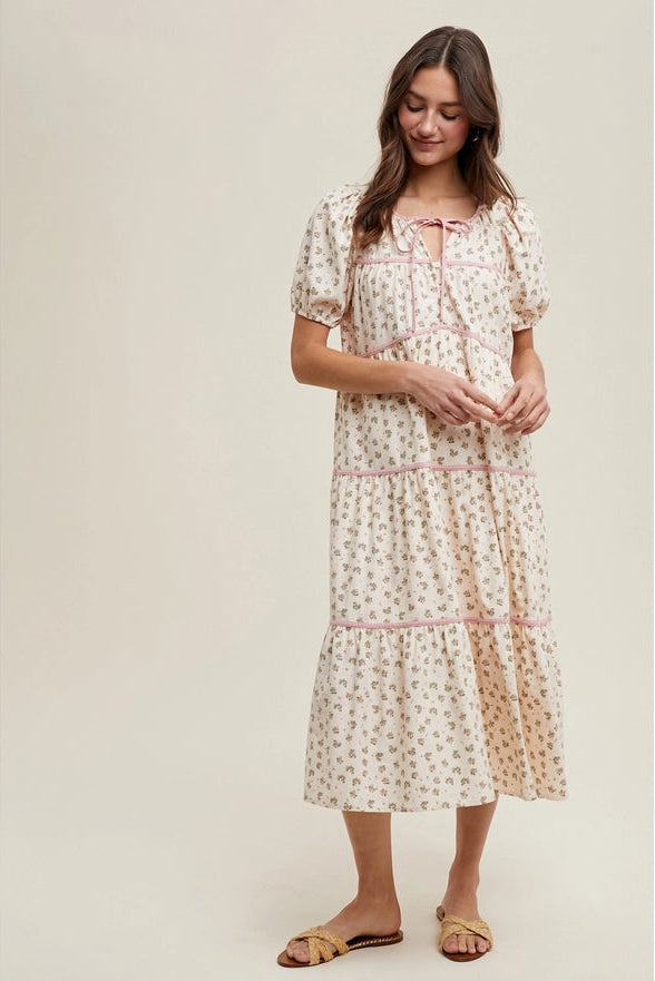 Woman wearing a floral dress with a plain background