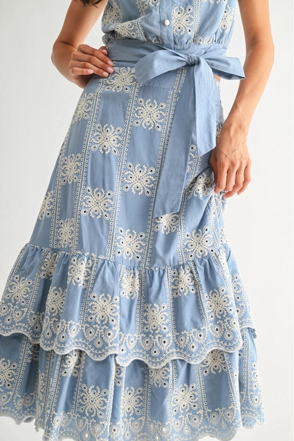 Blue dress with white floral patterns on a white background
