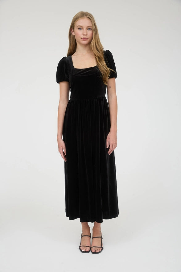 Woman wearing a black velvet dress on a white background