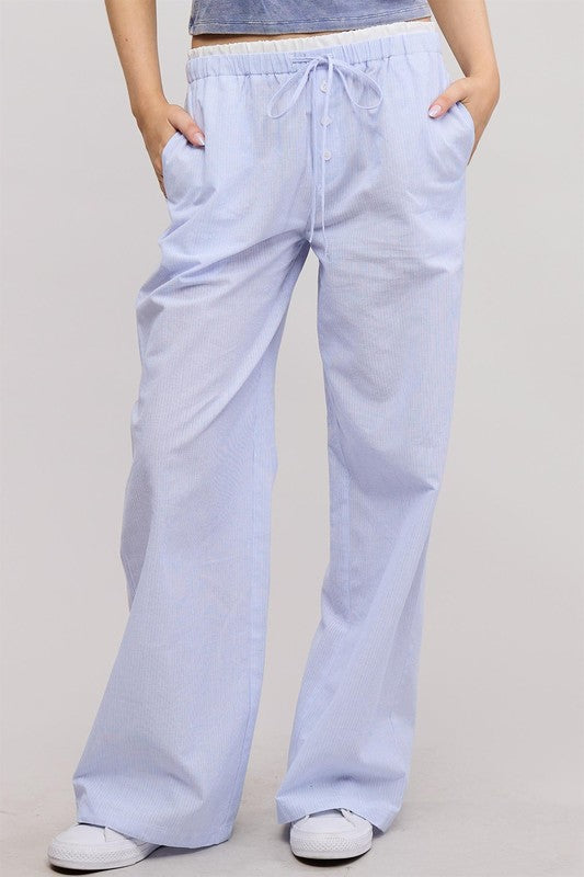 Light blue wide-leg pants worn by a person on a plain background