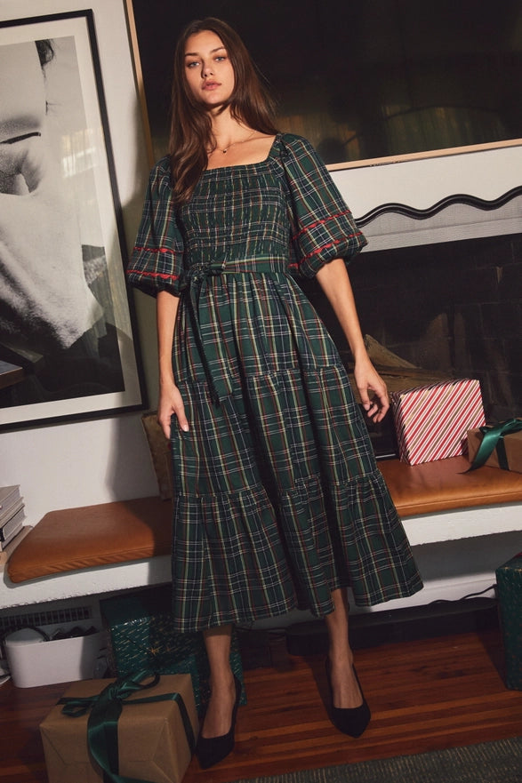 Woman wearing a green plaid midi dress with puff sleeves