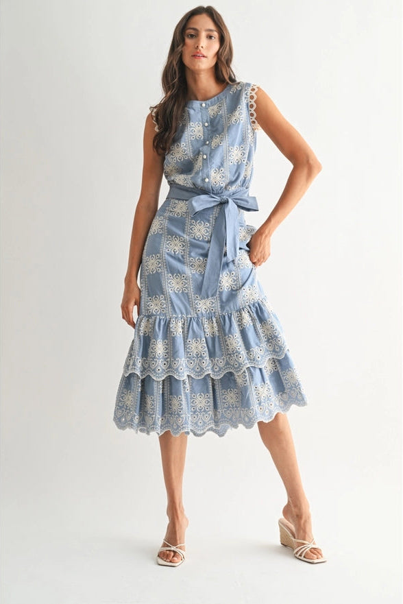 Woman wearing a blue floral dress on a white background