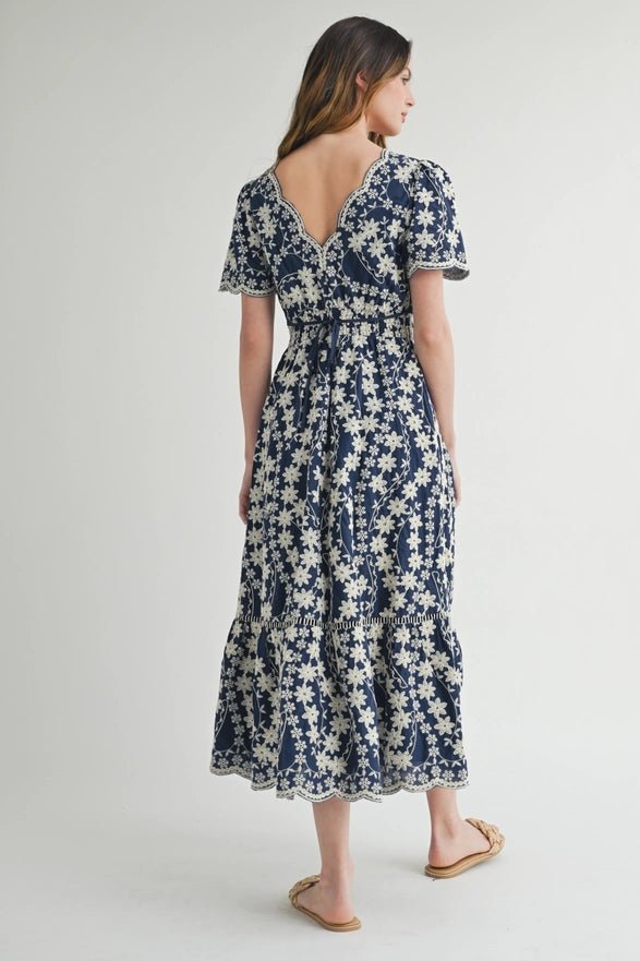 Woman wearing a blue floral dress on a white background