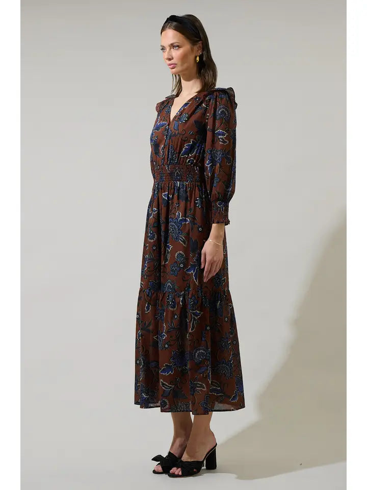 Woman wearing a brown patterned dress against a white background