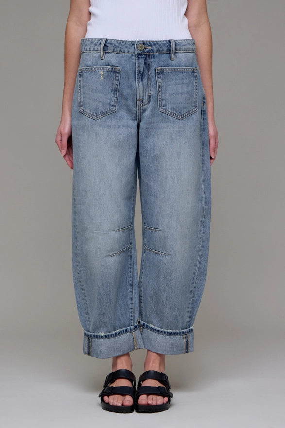 Light blue jeans worn by a person on a neutral background