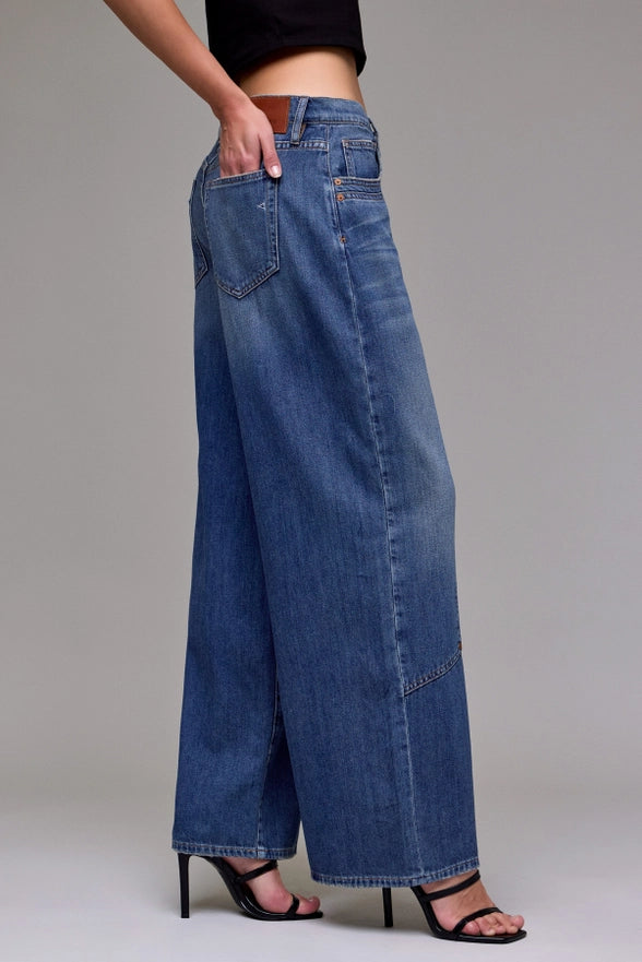 Wide-leg jeans worn by a person on a plain background