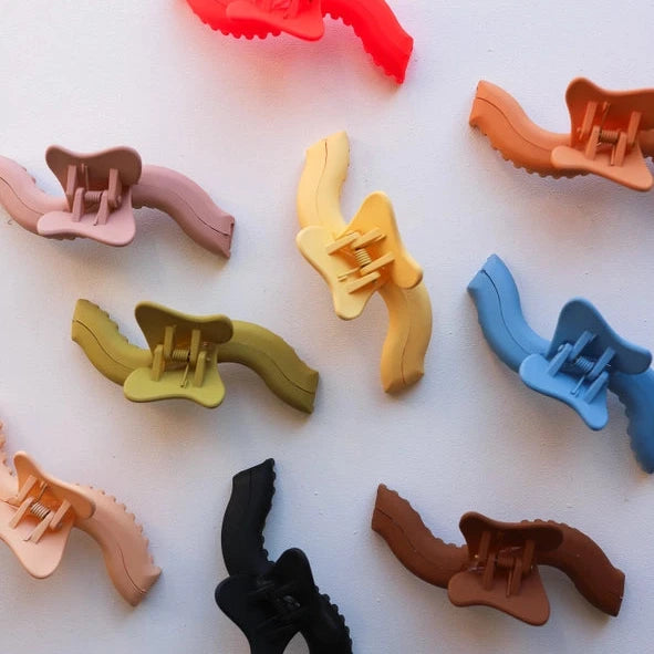 Colorful hair clips arranged on a white background